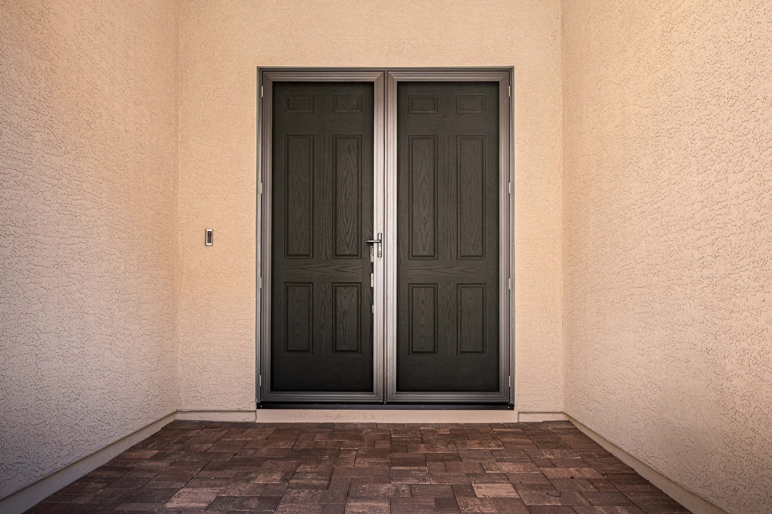 Reinforced front entry door with modern double-door design and secure locking system for home protection