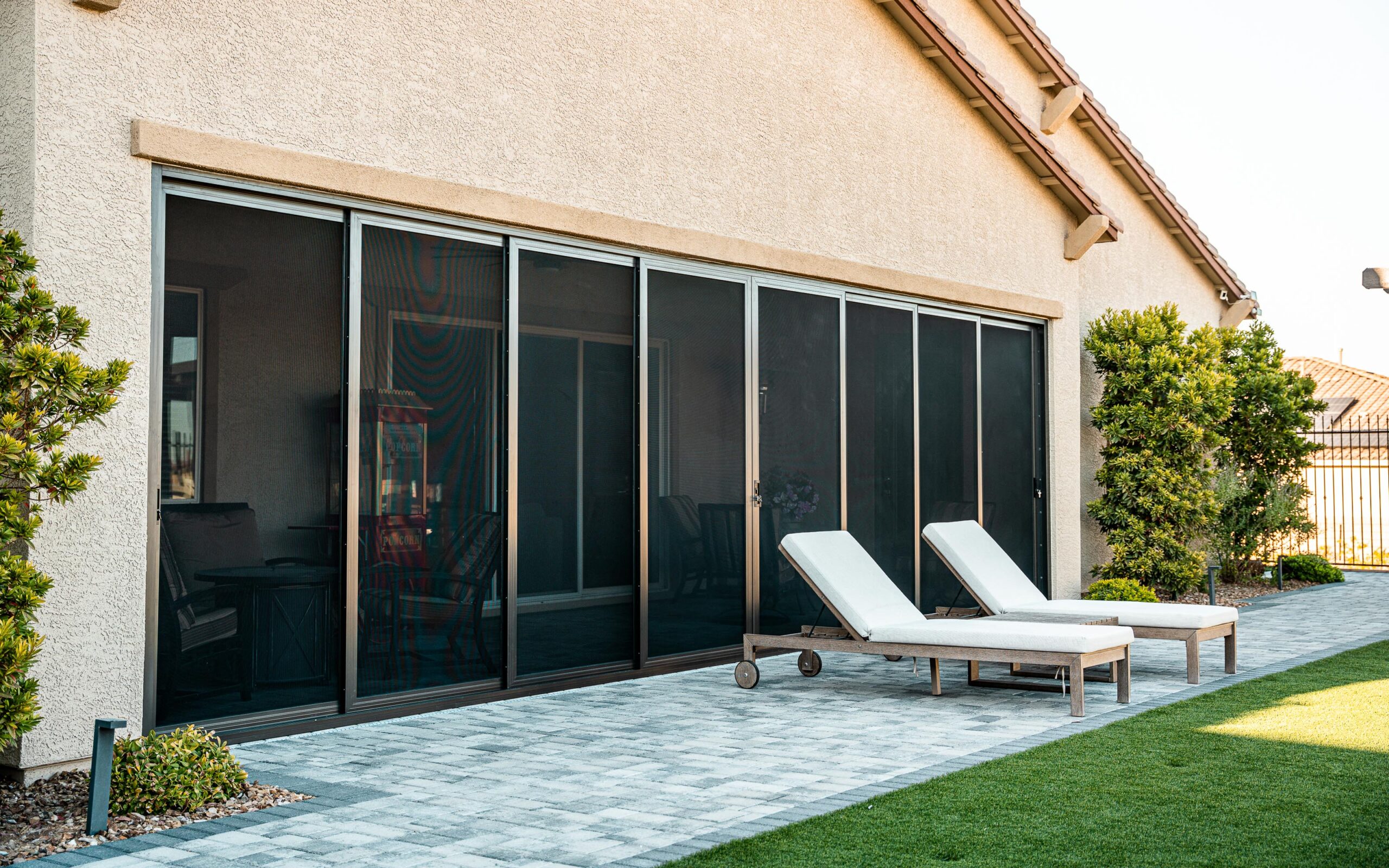 Modern home with Crimsafe security screens installed on sliding glass doors for stylish and secure patio access